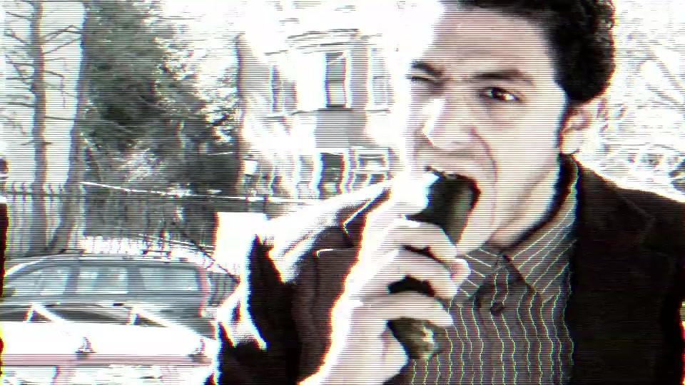 Mr. Mokhtar biting into a cucumber on a street